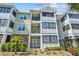 Attractive condo building showcasing balconies, neutral colors, decorative trim and lush, manicured landscaping at 1025 Riverland Woods Pl # 1008, Charleston, SC 29412