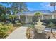 Charming clubhouse with manicured landscaping, palm trees, and stone water fountain at 1025 Riverland Woods Pl # 1008, Charleston, SC 29412