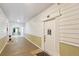 Hallway leading to unit featuring coastal paint colors, flooring and front door to unit 1006 at 1025 Riverland Woods Pl # 1008, Charleston, SC 29412
