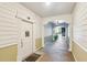 Hallway featuring front door to unit with view of staircase and entry beyond arched doorway at 1025 Riverland Woods Pl # 1008, Charleston, SC 29412