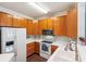 Well-lit kitchen featuring wood cabinets, stainless appliances, white countertops and recessed lighting at 1025 Riverland Woods Pl # 1008, Charleston, SC 29412