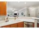 Open kitchen view of the dining and living areas with stainless appliances and white countertop at 1025 Riverland Woods Pl # 1008, Charleston, SC 29412