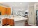 Bright kitchen with wooden cabinets and breakfast bar that opens to the living room at 1025 Riverland Woods Pl # 1008, Charleston, SC 29412