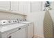 Functional laundry room with modern washer and dryer units and ample storage cabinets at 1025 Riverland Woods Pl # 1008, Charleston, SC 29412