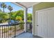 Patio features a black metal railing, sage siding, and a view of tropical landscaping at 1025 Riverland Woods Pl # 1008, Charleston, SC 29412