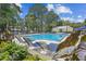 Inviting outdoor pool surrounded by lush greenery and comfortable lounge chairs, ideal for sunny days at 1025 Riverland Woods Pl # 1008, Charleston, SC 29412