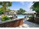 Beautiful community pool area with ample seating, lush landscaping, and a clubhouse in the background at 1025 Riverland Woods Pl # 1008, Charleston, SC 29412