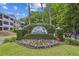 Community sign with address number displayed among colorful flowers and green landscaping at 1025 Riverland Woods Pl # 1008, Charleston, SC 29412