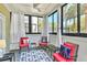 Bright sunroom with nautical decor, ceiling fan, and large windows showcasing palm trees at 1025 Riverland Woods Pl # 1008, Charleston, SC 29412