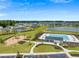 Aerial view of a community park featuring a playground and a swimming pool with a bath house at 103 Radtko Rd, Summerville, SC 29486