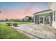 Backyard with decorative stone patio, screened in porch and lush lawn that overlooks neighborhood pond at 103 Radtko Rd, Summerville, SC 29486