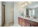 Well-lit bathroom featuring a double sink vanity and a glass enclosed shower with tiled walls at 103 Radtko Rd, Summerville, SC 29486