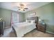 Cozy bedroom with a wooden bed frame, soft lighting, and tasteful decor at 103 Radtko Rd, Summerville, SC 29486