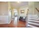Inviting foyer with hardwood flooring, staircase, decorative mirror, and bench at 103 Radtko Rd, Summerville, SC 29486