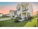 Home showcases manicured lawn, mulched garden beds, brick and siding facade, and concrete driveway at 103 Radtko Rd, Summerville, SC 29486