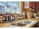 Modern kitchen sink with sleek faucet, granite countertops, and stylish backsplash at 103 Radtko Rd, Summerville, SC 29486