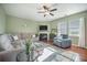 Cozy living room featuring hardwood flooring, plush sofas, a fireplace, and natural light at 103 Radtko Rd, Summerville, SC 29486