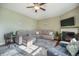 Cozy living room featuring hardwood flooring, plush sofas, a fireplace, and large windows providing ample light at 103 Radtko Rd, Summerville, SC 29486