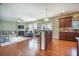 Open floor plan with kitchen, dining area, and living room featuring hardwood floors, fireplace, and natural light at 103 Radtko Rd, Summerville, SC 29486