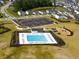 Aerial view of a community pool with lounge chairs and a nearby parking lot at 103 Radtko Rd, Summerville, SC 29486