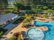 Aerial view of a community pool, playground, and covered seating with landscaping, surrounded by mature trees at 103 Radtko Rd, Summerville, SC 29486