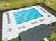 Aerial view of a rectangular pool with multiple chairs, surrounded by trees in a community at 103 Radtko Rd, Summerville, SC 29486