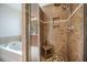 Elegant tiled shower with built-in shelving, a shower bench, and a rainfall shower head at 103 Radtko Rd, Summerville, SC 29486