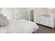 Well-lit bedroom featuring a dresser, modern decor, and an open doorway at 1033 Sagegrass St, Summerville, SC 29485