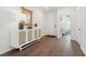 Inviting foyer featuring a stylish console table, a decorative mirror, and wood flooring at 1033 Sagegrass St, Summerville, SC 29485