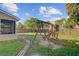 Well-manicured backyard with large playset, mature trees, and privacy fence at 1034 Sterling Ln, Summerville, SC 29483