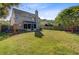 Large backyard with a privacy fence, playset, mature trees, and access to the screened porch at 1034 Sterling Ln, Summerville, SC 29483