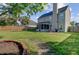 Spacious backyard features a well-maintained lawn, privacy fence, fire pit, and screened-in porch at 1034 Sterling Ln, Summerville, SC 29483