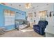 Bright blue bedroom with a crib, a comfortable chair, and natural light at 1034 Sterling Ln, Summerville, SC 29483