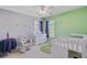Bright bedroom featuring a white crib, rocking chair, and natural light at 1034 Sterling Ln, Summerville, SC 29483