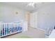 Charming bedroom featuring a crib, a white dresser, and a ceiling fan at 1034 Sterling Ln, Summerville, SC 29483