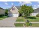 Charming two-story home with a well-maintained lawn, a mature tree, and a driveway leading to the garage at 1034 Sterling Ln, Summerville, SC 29483