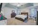 Spacious main bedroom with tray ceiling, carpet, and sitting area with desk at 1034 Sterling Ln, Summerville, SC 29483