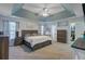 Spacious main bedroom featuring tray ceiling, carpet and ensuite bathroom at 1034 Sterling Ln, Summerville, SC 29483