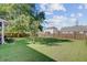 Large, beautifully landscaped backyard with mature trees and a privacy fence, offering ample space at 104 Valentin Dr, Summerville, SC 29483