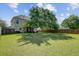 Spacious backyard with well-maintained lawn, mature trees, and fenced perimeter, ideal for outdoor activities at 104 Valentin Dr, Summerville, SC 29483