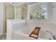 Relaxing bathroom featuring soaking tub, separate shower, and window with view at 104 Valentin Dr, Summerville, SC 29483