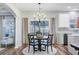Bright dining area featuring a round table and elegant chandelier near the kitchen and adjacent living area at 104 Valentin Dr, Summerville, SC 29483