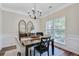 Elegant dining room with chandelier, decorative windows, and stylish furnishings at 104 Valentin Dr, Summerville, SC 29483