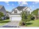 Charming two-story home with a well-manicured lawn, attached garage and beautiful landscaping at 104 Valentin Dr, Summerville, SC 29483