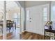Foyer with hardwood flooring, white trim, columns, and adjacent dining room at 104 Valentin Dr, Summerville, SC 29483