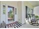 Inviting front porch with decorative mat, rocking chairs, and view of the landscaped yard at 104 Valentin Dr, Summerville, SC 29483