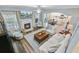 Open-concept living room with fireplace, mounted TV, and view into the kitchen area at 104 Valentin Dr, Summerville, SC 29483