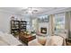 Comfortable living room with a fireplace, built-in shelving, TV, and natural light creating a cozy ambiance at 104 Valentin Dr, Summerville, SC 29483