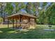 A wooden pavilion with picnic tables provides a shaded area for outdoor gatherings and dining at 104 Valentin Dr, Summerville, SC 29483