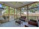 Inviting screened porch with comfortable wicker furniture and a ceiling fan for relaxing outdoors at 104 Valentin Dr, Summerville, SC 29483